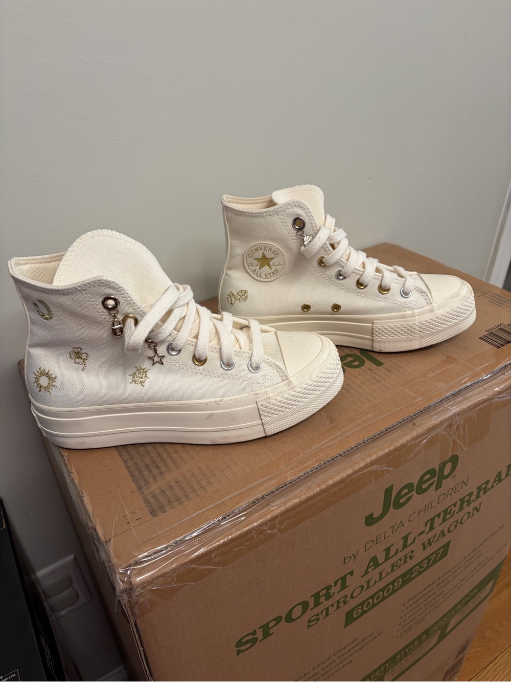 Converse High Top Sneakers in Cream with Gold Accents. Slight platform